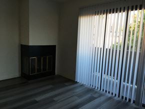 Los Angeles apartment for rent - a living room with a large window blinds and a fireplace