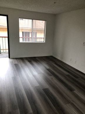 Los Angeles apartment for rent - an empty living room with wooden floors and a window