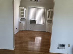 Los Angeles apartment for rent - an empty living room with wooden floors and a window