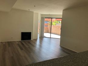 Los Angeles apartment for rent - an empty living room with wood floors and a sliding glass door