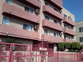 Los Angeles apartment for rent - a pink fence in front of an apartment building