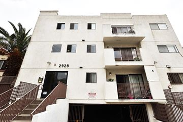 Los Angeles apartment for rent - A tall white building with the number 2926 on the front.