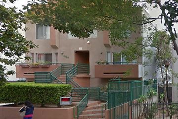 Los Angeles apartment for rent - an apartment building with stairs and green railings