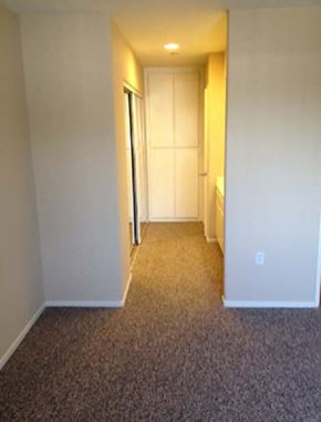 Sherman Oaks apartment for rent - a hallway with a door to a bedroom and a closet