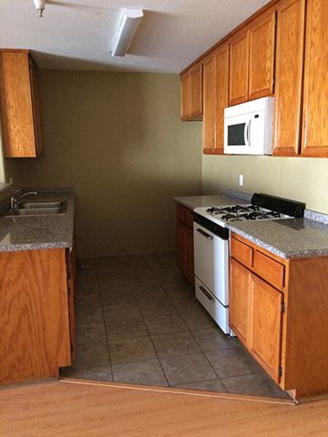 Sherman Oaks apartment for rent - a kitchen with a stove and a sink and a microwave