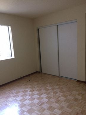 Los Angeles apartment for rent - an empty room with a window and two closet doors