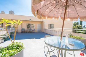 North Hollywood apartment for rent - a patio with an umbrella and a table