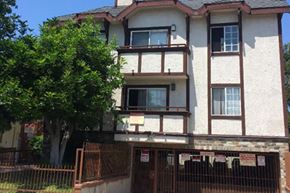 Los Angeles apartment for rent - a house with a fence and a tree in front of it
