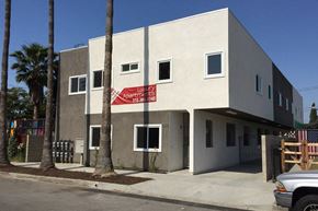North Hollywood apartment for rent - a white building with a red sign in front of it