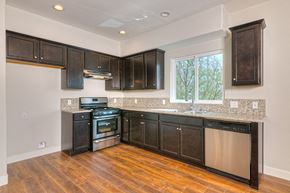 North Hollywood apartment for rent - a kitchen with dark wood cabinets and a window