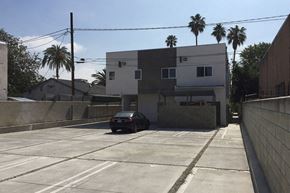 North Hollywood apartment for rent - a car parked in a parking lot in front of a building