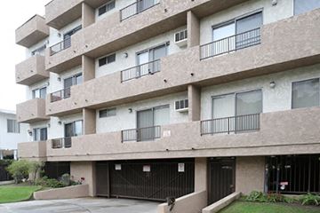 Los Angeles apartment for rent - a large apartment building with garage doors in front of it