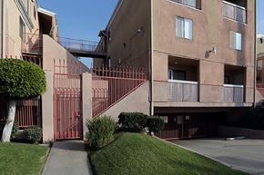 Los Angeles apartment for rent - an exterior view of a building with stairs and a sidewalk