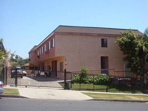Los Angeles apartment for rent - a brown building with a fence and a gate