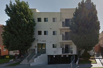 Los Angeles apartment for rent - a white building with stairs and trees in front of it