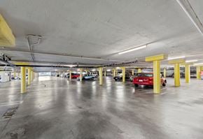 Winnetka apartment for rent - a parking garage filled with cars and yellow pillars