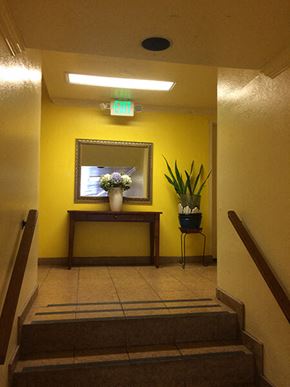 Los Angeles apartment for rent - a hallway with a mirror and a vase with flowers