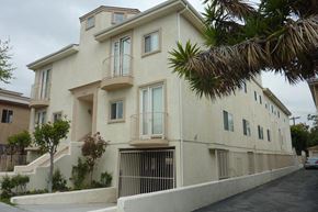 Los Angeles apartment for rent - a white building with a balcony and a palm tree
