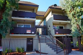 North Hills apartment for rent - an apartment building with stairs and a fence in front of it