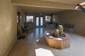 Canoga Park apartment for rent - the lobby of an apartment building with a reception area and a fountain