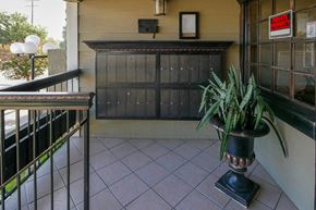 Canoga Park apartment for rent - a plant in a vase on the balcony of a building