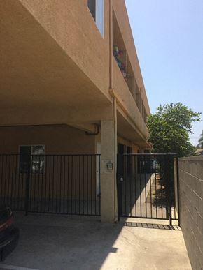Panorama City apartment for rent - the side of a building with a fence and a gate