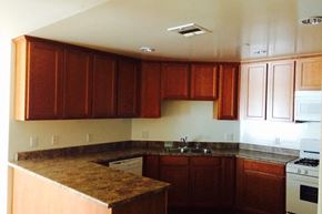 Los Angeles apartment for rent - an empty kitchen with wooden cabinets and white appliances