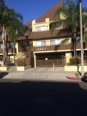 Los Angeles apartment for rent - an apartment building with a driveway and palm trees