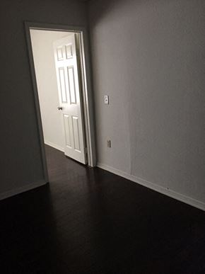 Van Nuys apartment for rent - a door is open to a room with a wooden floor