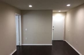 Van Nuys apartment for rent - an empty living room with white walls and a wooden floor