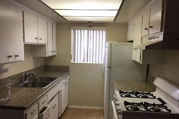 Van Nuys apartment for rent - a kitchen with a stove and a sink and a refrigerator