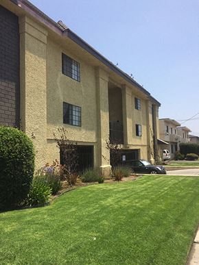 Van Nuys apartment for rent - a building with a green lawn in front of it