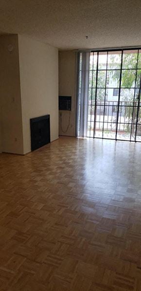 Venice apartment for rent - an empty living room with a wooden floor and a window