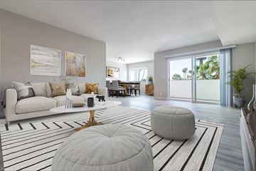 Long Beach townhouse for rent - A modern living room with a white couch and a large window.