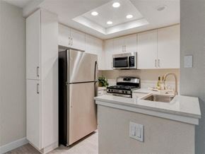 Laguna Niguel apartment for rent - a kitchen with a refrigerator freezer next to a stove top oven  at Laguna Gardens Apts., California