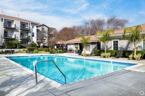 San Ramon apartment for rent - A swimming pool surrounded by a concrete patio and apartment buildings at Cornerstone at Gale Ranch Apartments, San Ramon, CA