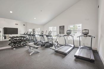 Gym with cardio equipment at the bradley braddock road station apartments