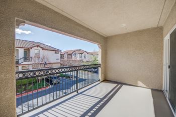 A balcony with a view of a street and houses