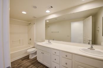 A bathroom with a toilet sink and bathtub