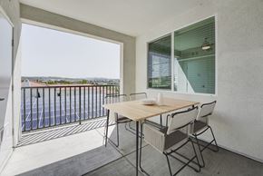Carlsbad apartment for rent - A balcony with a table and chairs overlooking a pool at Montecito at Carlsbad, Carlsbad, CA 92010