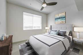 Carlsbad apartment for rent - A bedroom with a large bed and a ceiling fan at Montecito at Carlsbad, Carlsbad, CA 92010