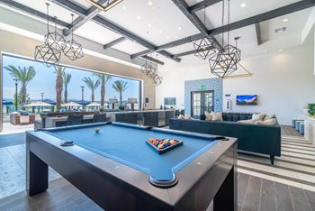 Clubhouse with pool table and lounge area at the bradley braddock road station apartments