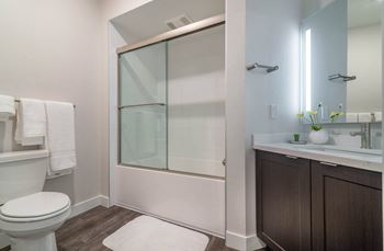 A bathroom with a toilet sink and shower