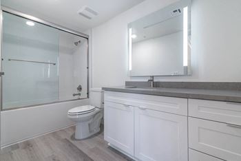 A bathroom with a sink toilet and shower