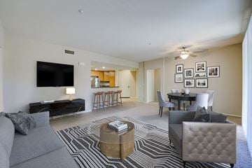 Porter Ranch apartment for rent - a living room with a couch and a table with chairs and a television
