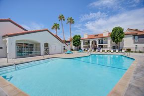 Laguna Niguel apartment for rent - a large swimming pool with lounge chairs and palm trees in the background  at Laguna Gardens Apts., Laguna Niguel, California
