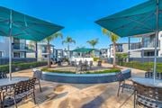 Long Beach apartment for rent - a courtyard with tables and chairs and umbrellas at Park Avenue Apartments, Long Beach, California