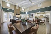 Porter Ranch apartment for rent - a resident clubhouse with a fireplace and dining table  at Ventana Senior Apartments, California, 91326