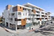 Culver City apartment for rent - A modern multi-story building with a white and brown facade.