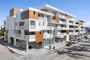 Culver City apartment for rent - A modern multi-story building with a white and brown facade.